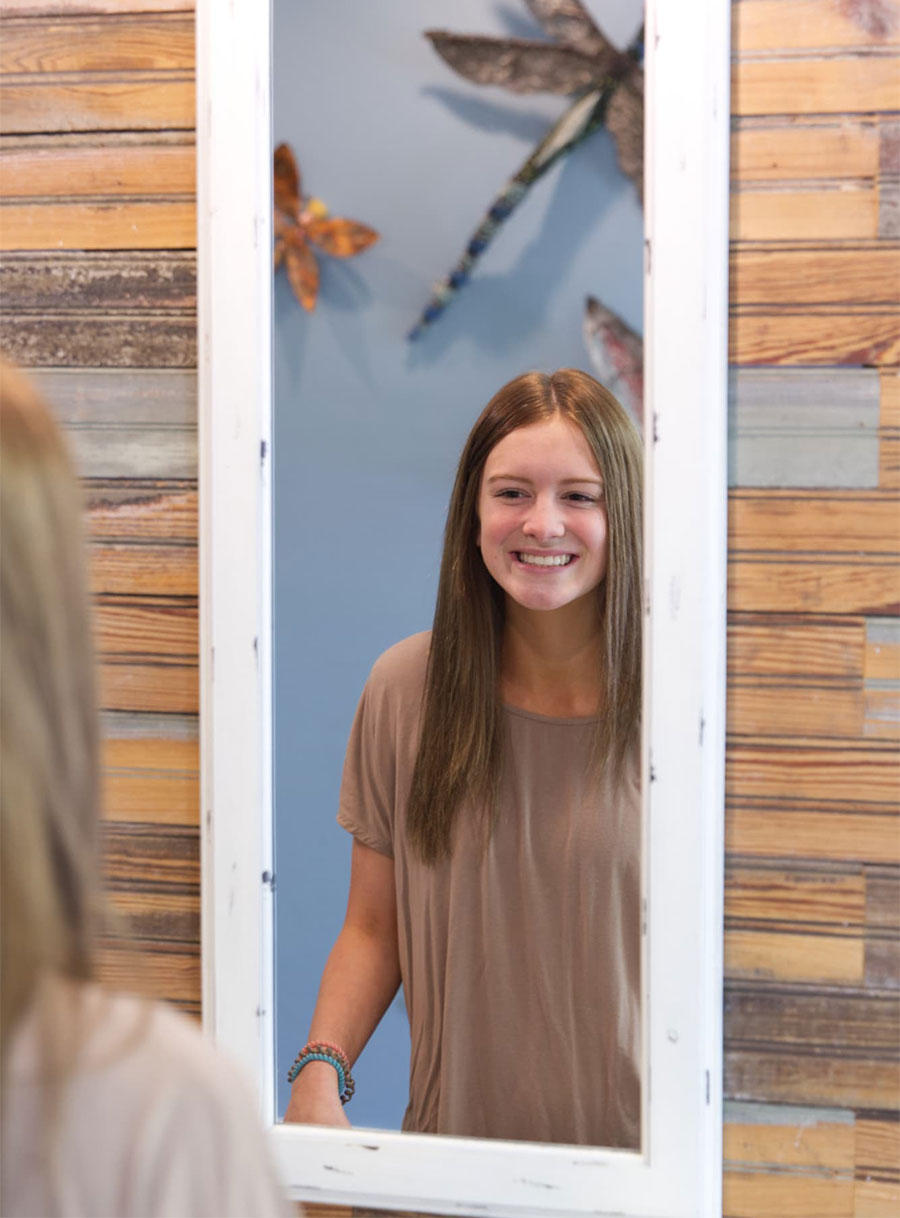 williams orthodontics patient smiling in mirror